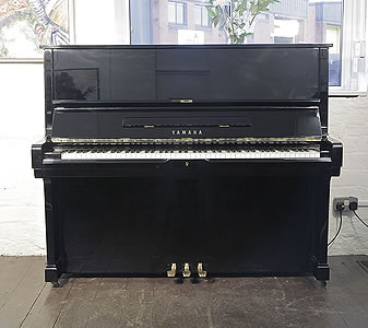 A 1980, Yamaha U2 upright piano with a black case and polyester finish