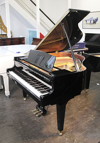 Piano for sale. A 2017, Kawai GE20 baby grand piano for sale with a black case and square, tapered legs.