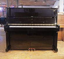 A 1998, Steinway Model V upright piano with a black case and brass fittings