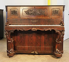 Antique, Ernst Irmler upright piano for sale with an ornately carved, rosewood case with reverse scroll legs with carved female heads