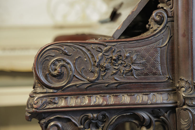 Francke carved piano cheek detail featuring scrolling acanthus and flowers