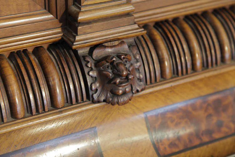 German  piano cabinet detail featuring grotesque heads
