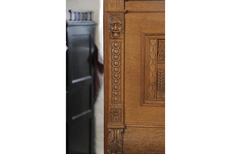 Helmholz carved pilaster featuring a grotesque head, rosette and strapwork