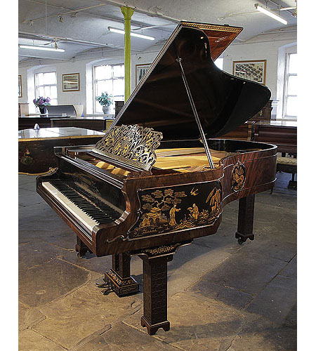 An 1899, Chinese Chippendale style, Schiedmayer grand piano for sale with a flame mahogany case and Malborough legs with applied fret carvings. Cabinet features Chinese scenes in embossed Japanning with gilt ornament