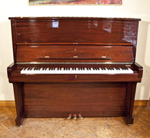 A 1985, Steinway Model K upright piano with a mahogany case and brass fittings