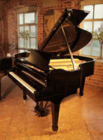 A 1936, Steinway Model M grand piano with a black case and spade legs