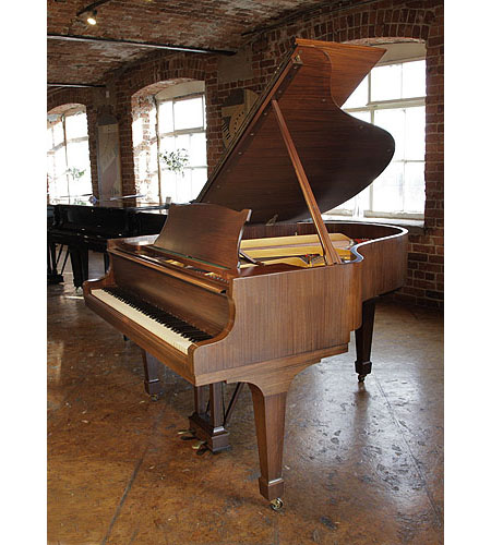 Restored,  1961, Steinway Model M grand piano with a satin, walnut case and spade legs.  Piano has an eighty-eight note keyboard and a two-pedal lyre.  