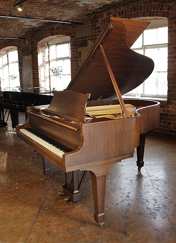 Restored,  1961, Steinway Model M grand piano with a satin, walnut case and spade legs. Piano has an eighty-eight note keyboard and a two-pedal lyre.
