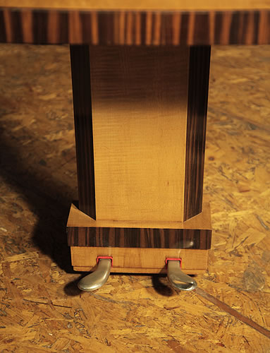 The two-pedal piano lyre is in a simple geometric design with a rectangular central support in maple with chamfered edges of coromandel accents