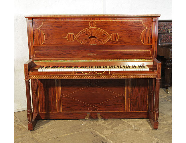 A 1912, Weber upright piano for sale with a flame mahogany case and turned, fluted legs. Cabinet inlaid with a stylised, Neoclassical design featuring geometric forms in a variety of woods. Piano has an eighty-eight keyboard and two pedals. 