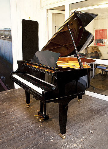 A Yamaha GC1 baby grand piano for sale with a black case and square, tapered legs. Piano features a QuietTime Magic Star system