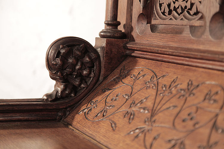 Gebruder Knake piano cheek featuring an ornately carved, floral rosette.