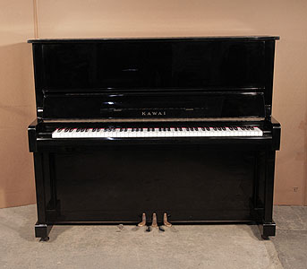  A 1973, Kawai BL-11 upright piano with a black case and polyester finish. Piano has an eighty-eight note keyboard and three pedals. .