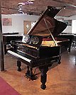 Restored, 1881, Steinway Model B grand piano with a black case, music desk in a foliar cut-out design and elephant legs. Piano has a two-pedal lyre and an eighty-five note keyboard.