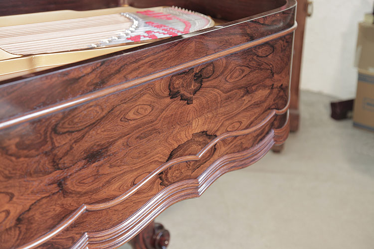 Steinway Centennial sinuous wave pattern double moulding surrounds the cabinet base