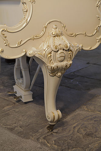 Steinway model O cabriole piano leg ornately, carved with anthemions, cabuchons and scrolling foliage with gilt accents.