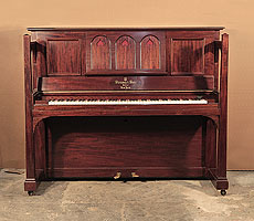 Arts and Crafts style, 1905, Steinway upright piano for sale with a figured, mahogany case and large sculptural legs. Cabinet features a music desk in a three arch design with cut-out inverted hearts backed with red felt. Piano has an eighty-eight note keyboard and two pedals.