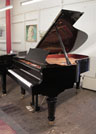 Piano for sale. A brand new, Toyama TC-187 grand piano for sale with a black case and turned, faceted legs.