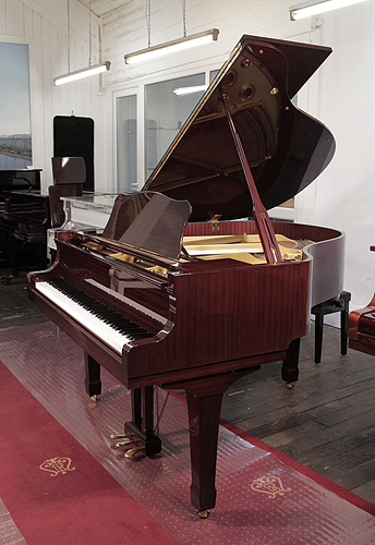 Reconditioned, 1993, Yamaha grand piano with a mahogany case and spade legs.