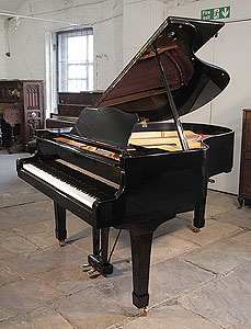 A 1974, Yamaha G2 grand piano for sale with a black case and spade legs  Piano has an eighty-eight note keyboard and a two-pedal lyre.