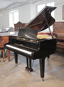 A 1988, Yamaha GH1 baby grand piano for sale with a black case and square, tapered legs. Piano has an eighty-eight note keyboard and a three-pedal lyre.