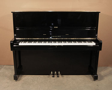  A 1977, Yamaha U1 upright piano with a black case and polyester finish. Piano has an eighty-eight note keyboard and three pedals.