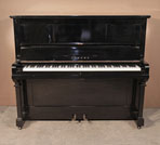 Piano for sale. A 1962, Yamaha U2 upright piano with a black case and brass fittings. Piano has an eighty-eight note keyboard and two pedals  