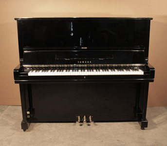  A 1975, Yamaha U3 upright piano for sale with a black case and brass fittings. Piano has an eighty-eight note keyboard and three pedals. .
