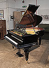 A restored, Bechstein Model A grand piano with a black case and turned legs