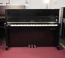 Reconditioned,  2000, Kawai CX-5H upright piano with a black case and fitted Kawai silent system. Piano has an eighty-eight note keyboard and three pedals. 