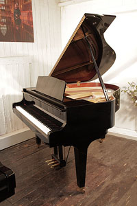 A 2003, Kawai GM-10 baby grand piano for sale with a black case and square, tapered legs. Piano has an eighty-eight note keyboard and a three-pedal lyre.