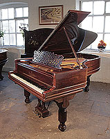 An 1896, Steinway Model B grand piano for sale with a rosewood case, filigree music desk and fluted, barrel legs. Piano has a three-pedal lyre and an eighty-five note keyboard.
