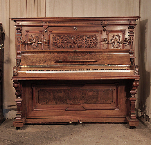  Neoclassical style, Steinweg Nachf upright piano for sale with a carved, walnut case and ornate candlesticks. Cabinet features a front panel carved with cabuchons, and c-scrolls in high relief