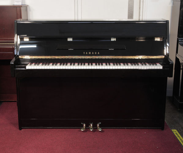 Yamaha  C110A upright piano for sale with a black case and brass fittings