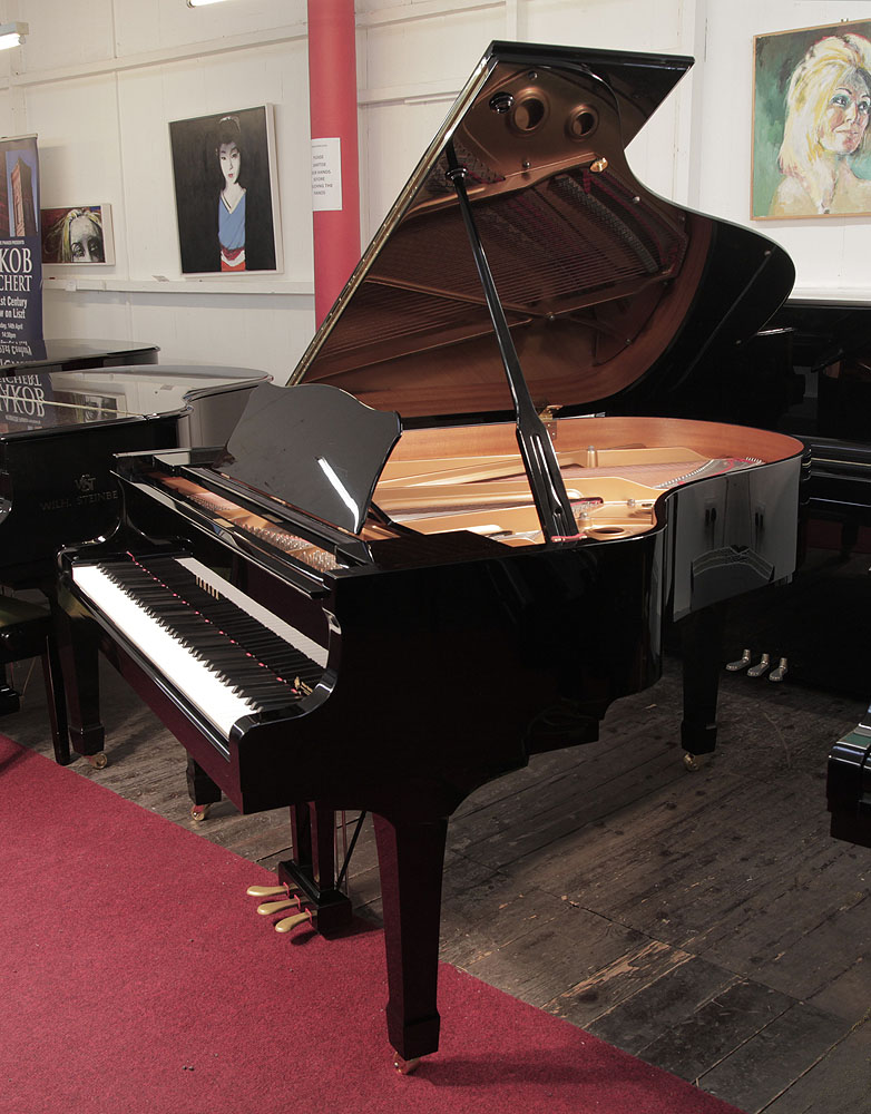 Yamaha C3 grand piano for sale with a black case and spade legs . Buy a