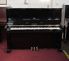 Reconditioned,  1977, Yamaha U1 upright piano with a black case and polyester finish. Piano has an eighty-eight note keyboard and three pedals. 