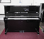 Piano for sale. A Feurich Model 122 upright piano with a black case and chrome fittings.