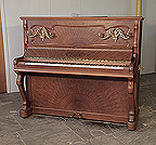 Piano for sale. Art Nouveau style, Focke upright piano for sale with a sunburst walnut case and ornate, brass candlesticks Piano has an eighty-five keyboard and two pedals. 