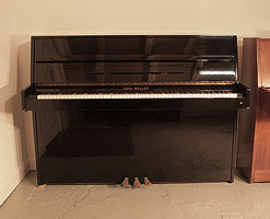 A Karl Muller Upright Piano For Sale with a Black Case and Brass Fittings