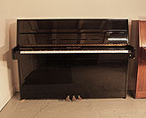 Piano for sale. Karl Muller Upright Piano For Sale with a Black Case and Brass Fittings. Piano has an eighty-eight note keyboard and three pedals.