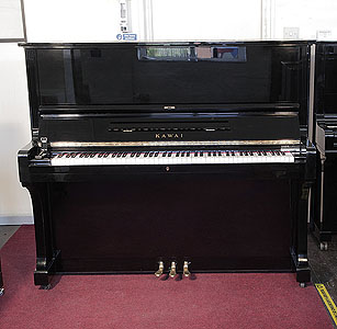 A 1976, Kawai BL-61 upright piano with a black case and polyester finish. Piano has an eighty-eight note keyboard and three pedals.  