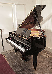A 2009, Kawai GM-10K baby grand piano for sale with a black case and square, tapered legs. Piano has an eighty-eight note keyboard and a three-pedal lyre.