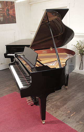Piano for sale. A   Kawai GM-10 baby grand piano for sale with a black case and square, tapered legs. Piano has an eighty-eight note keyboard and a three-pedal lyre.