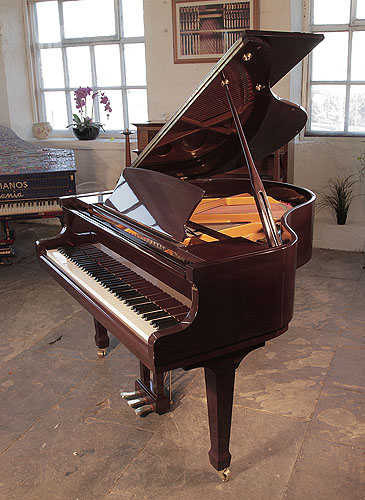  Reconditioned, Bentley GP142 baby grand piano for sale with a mahogany case and spade legs Piano has an eighty-eight note keyboard and a three-pedal lyre. 
