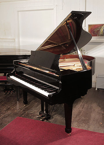 Piano for sale. Reconditioned, 1970, Kawai KG-2   grand piano for sale with a black case and spade legs. Piano has an eighty-eight note keyboard and a two-pedal lyre.