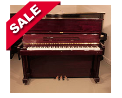 Piano for sale. Samick SU-121 upright piano with a mahogany case and brass fittings. Piano has an eighty-eight note keyboard and three pedals.