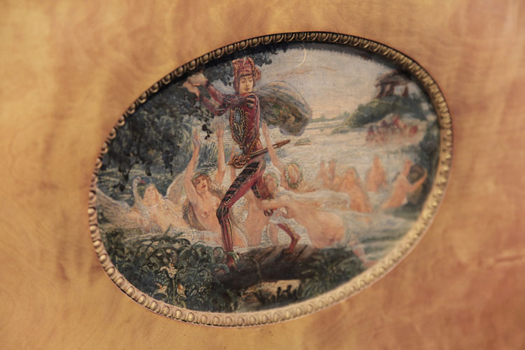 Hand-painted oval by Danish artist Gudmund Hentze. A man flees across a river with a golden cup pursued by nymphs dragging at his legs