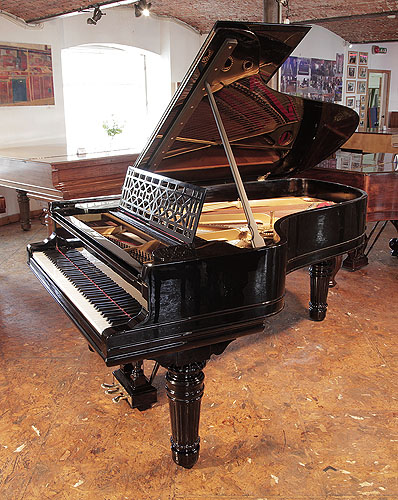 An 1898, Steinway Model B Grand piano for sale with a black case, cut-out music desk in a geometric design and fluted, barrel legs