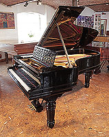Steinway Model B grand piano for sale with a black case, cut-out music desk in a geometric design and fluted, barrel legs