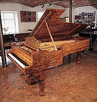 An 1880, Steinway & Sons Model D concert grand piano with a burr walnut case, filigree music desk and fluted, barrel legs.